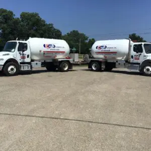 Two cement trucks parked in a parking lot.